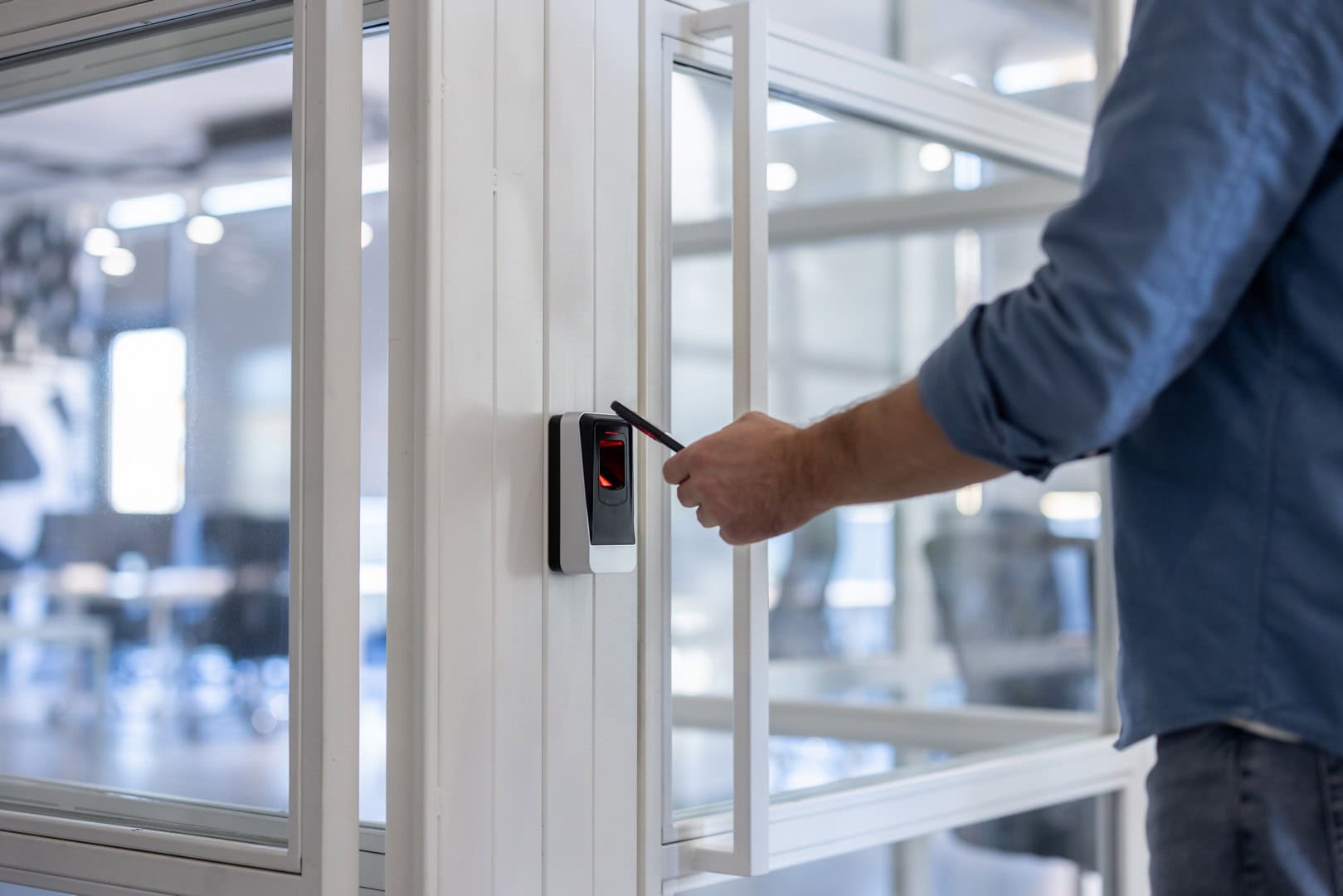 Person using a contactless reader to open an office door