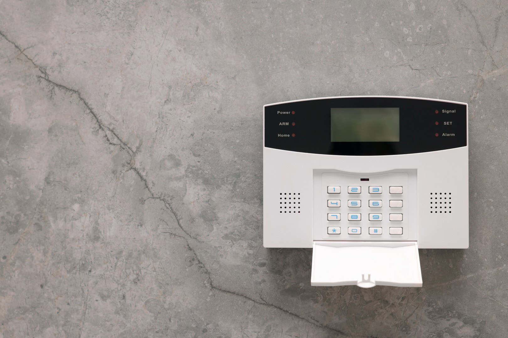 Home security alarm keypad mounted on a wall