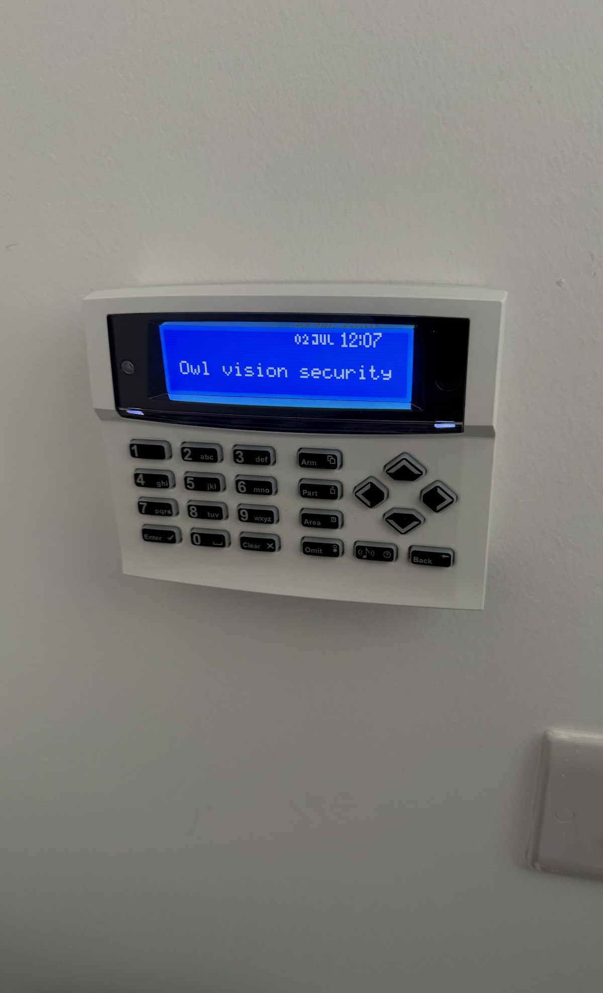 Home security alarm keypad mounted on a wall